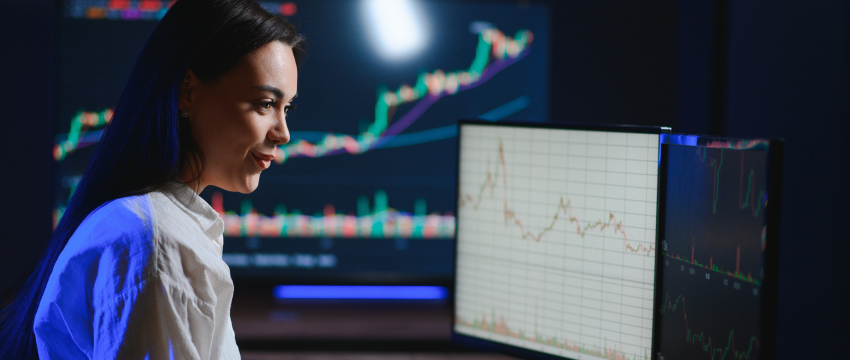 A woman trader analyzing forex charts on a screen, focused on MT4 basics for new traders, trading indicators, and market trends.